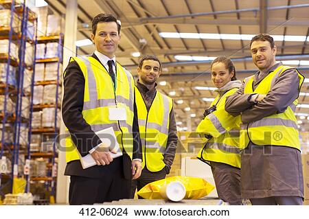 Businessman and workers smiling in warehouse View Large Photo Image Picture - Businessman and workers smiling in warehouse. Fotosearch