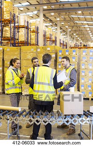 Businessman and workers talking in warehouse View Large Photo Image Stock Image - Businessman and workers talking in warehouse. Fotosearch