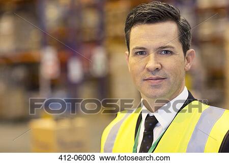 Businessman standing in warehouse View Large Photo Image Stock Image - Businessman standing in warehouse. Fotosearch