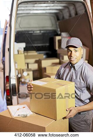 Stock Photo - Delivery boy loading boxes into van. Fotosearch