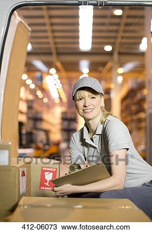 Delivery girl checking boxes in van View Large Photo Image Stock Image - Delivery girl checking boxes in van. Fotosearch