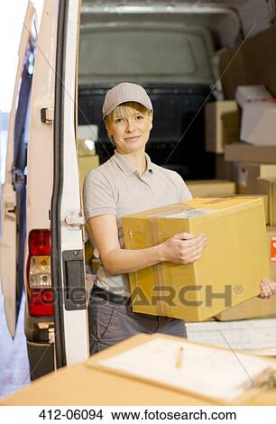 Picture - Delivery girl unloading boxes from van. Fotosearch