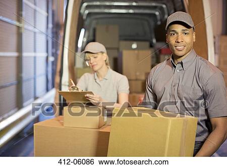 Delivery people loading boxes into van View Large Photo Image Stock Photograph - Delivery people loading boxes into van. Fotosearch