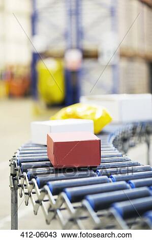 Stock Image - Packages on conveyor belt in warehouse. Fotosearch