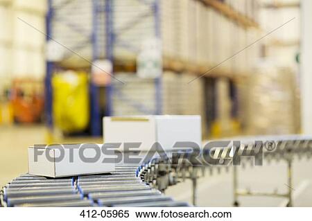 Packages on conveyor belt in warehouse View Large Photo Image Stock Photography - Packages on conveyor belt in warehouse. Fotosearch