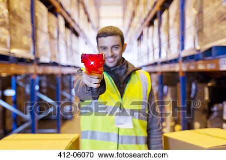 Worker holding scanner in warehouse View Large Photo Image Stock Image - Worker holding scanner in warehouse. Fotosearch