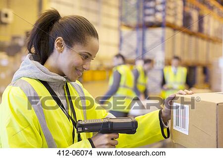 Worker scanning box in warehouse View Large Photo Image Picture - Worker scanning box in warehouse. Fotosearch