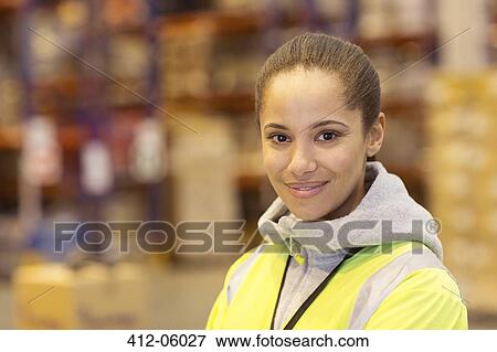 Stock Photo - Worker smiling in warehouse. Fotosearch