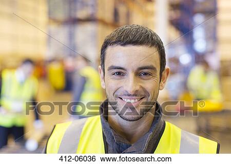 Worker smiling in warehouse View Large Photo Image Stock Photograph - Worker smiling in warehouse. Fotosearch