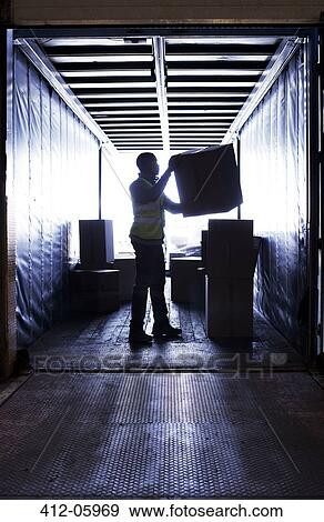 Worker stacking boxes in van View Large Photo Image Stock Photo - Worker stacking boxes in van. Fotosearch