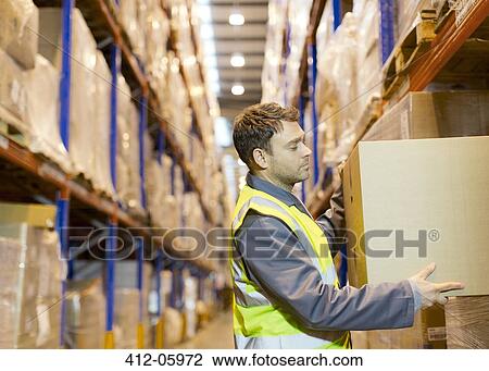 Worker stacking boxes in warehouse View Large Photo Image Stock Image - Worker stacking boxes in warehouse. Fotosearch
