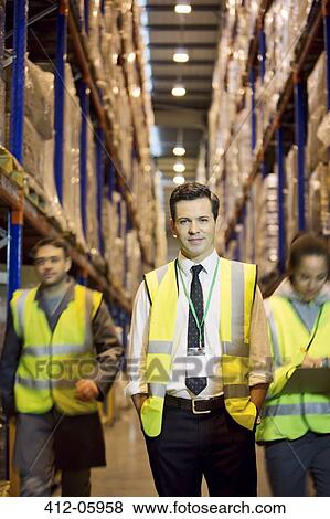 Worker standing in warehouse View Large Photo Image Stock Photo - Worker standing in warehouse. Fotosearch