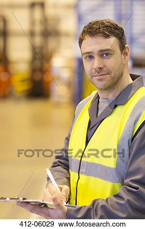 Worker using clipboard in warehouse View Large Photo Image Stock Photo - Worker using clipboard in warehouse. Fotosearch