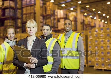 Workers and businesswoman in warehouse View Large Photo Image Stock Image - Workers and businesswoman in warehouse. Fotosearch