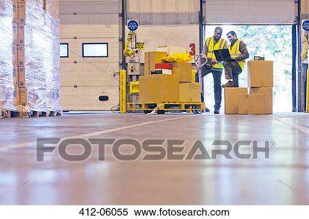 Workers checking boxes in warehouse View Large Photo Image Stock Photography - Workers checking boxes in warehouse. Fotosearch