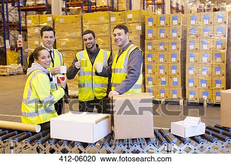Workers drinking coffee in warehouse View Large Photo Image Stock Image - Workers drinking coffee in warehouse. Fotosearch
