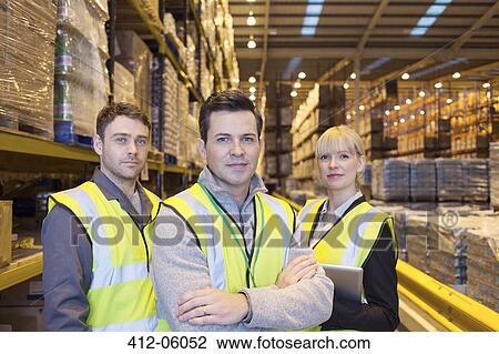 Workers smiling in warehouse View Large Photo Image Stock Image - Workers smiling in warehouse. Fotosearch