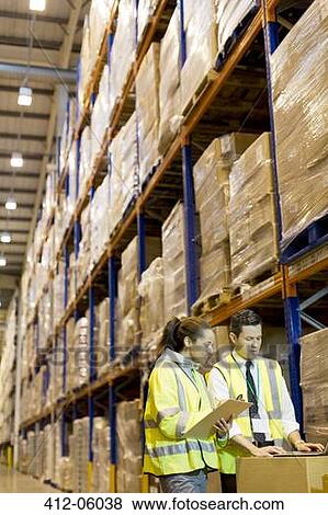 Workers talking in warehouse View Large Photo Image Stock Photo - Workers talking in warehouse. Fotosearch