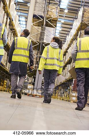 Workers walking in warehouse View Large Photo Image Stock Photograph - Workers walking in warehouse. Fotosearch
