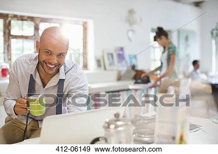 Businessman using laptop at breakfast View Large Photo Image Stock Photo - Businessman using laptop at breakfast. Fotosearch