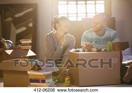 Couple eating sushi together in new home View Large Photo Image Stock Photo - Couple eating sushi together in new home. Fotosearch