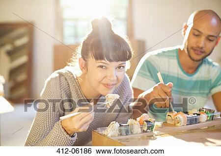 Couple eating sushi together View Large Photo Image Stock Photograph - Couple eating sushi together. Fotosearch
