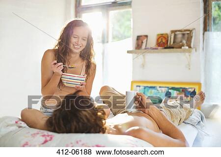 Couple having breakfast together in bed View Large Photo Image Stock Photo - Couple having breakfast together in bed. Fotosearch