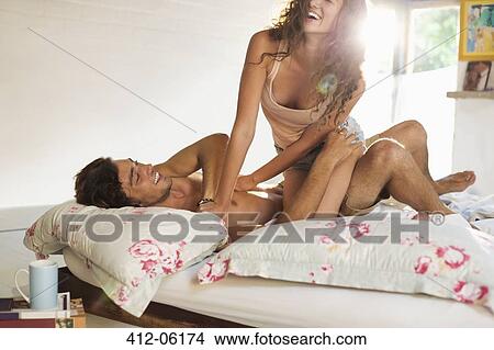 Picture - Couple playing in bed. Fotosearch