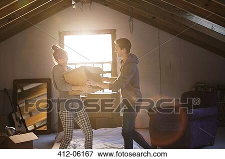 Couple unpacking box in attic View Large Photo Image Stock Photo - Couple unpacking box in attic. Fotosearch