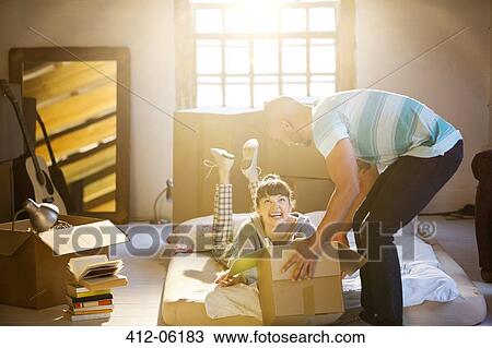 Couple unpacking boxes in attic View Large Photo Image Stock Image - Couple unpacking boxes in attic. Fotosearch