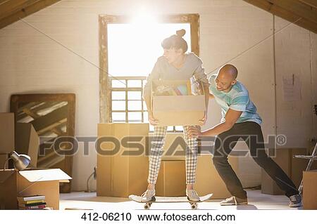 Couple unpacking boxes in new home View Large Photo Image Stock Image - Couple unpacking boxes in new home. Fotosearch