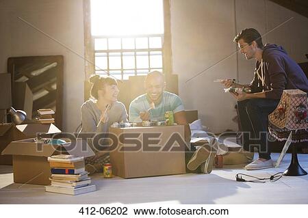 Friends eating sushi in new home View Large Photo Image Stock Image - Friends eating sushi in new home. Fotosearch