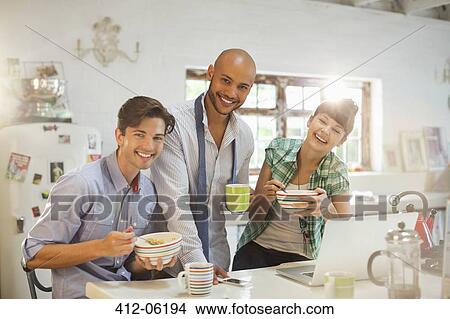 Friends having breakfast together in kitchen View Large Photo Image Picture - Friends having breakfast together in kitchen. Fotosearch