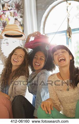 Stock Image - Friends playing together in bedroom. Fotosearch