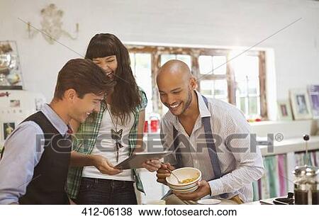 Friends relaxing together in kitchen View Large Photo Image Stock Photo - Friends relaxing together in kitchen. Fotosearch