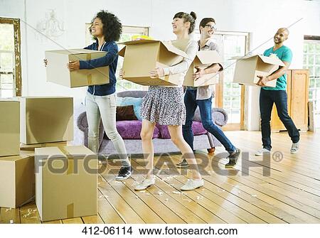 Friends unpacking boxes in new home View Large Photo Image Picture - Friends unpacking boxes in new home. Fotosearch