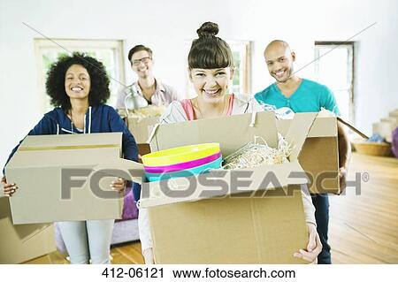 Friends unpacking boxes in new home View Large Photo Image Stock Image - Friends unpacking boxes in new home. Fotosearch