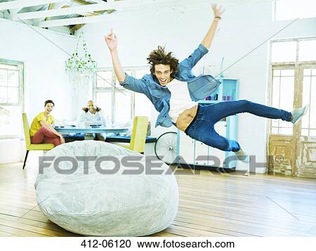 Man jumping into beanbag chair View Large Photo Image Stock Image - Man jumping into beanbag chair. Fotosearch