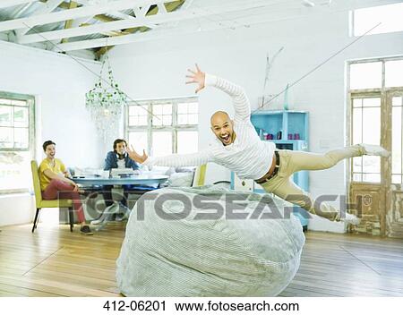 Man jumping into beanbag chair View Large Photo Image Stock Image - Man jumping into beanbag chair. Fotosearch