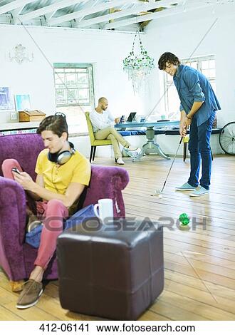 Men relaxing together in living room View Large Photo Image Stock Image - Men relaxing together in living room. Fotosearch