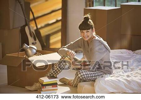 Woman holding book in bed View Large Photo Image Stock Image - Woman holding book in bed. Fotosearch