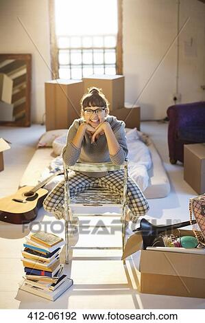 Woman unpacking boxes in attic View Large Photo Image Stock Image - Woman unpacking boxes in attic. Fotosearch