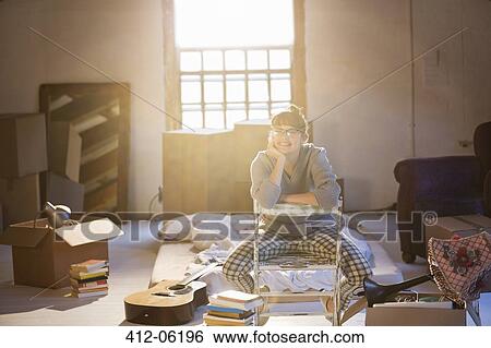 Woman unpacking boxes in attic View Large Photo Image Stock Photograph - Woman unpacking boxes in attic. Fotosearch