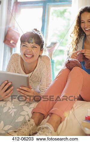 Women relaxing together in bedroom View Large Photo Image Stock Image - Women relaxing together in bedroom. Fotosearch