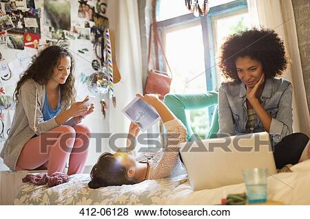 Stock Photo - Women relaxing together in bedroom. Fotosearch