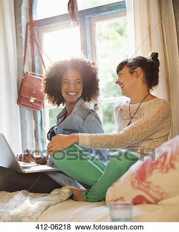 Women relaxing together in bedroom View Large Photo Image Stock Photo - Women relaxing together in bedroom. Fotosearch