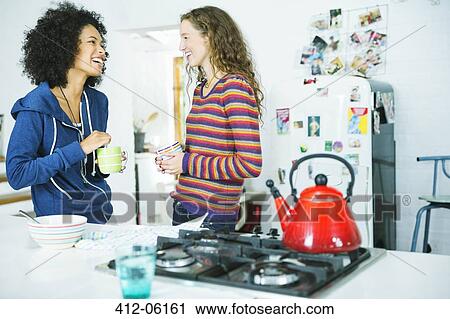 Women talking in kitchen View Large Photo Image Stock Image - Women talking in kitchen. Fotosearch