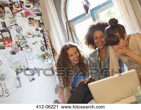 Women using laptop together in bedroom View Large Photo Image Stock Image - Women using laptop together in bedroom. Fotosearch