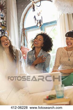Women using laptop together in bedroom View Large Photo Image Stock Photo - Women using laptop together in bedroom. Fotosearch