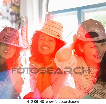 Women wearing hats in bedroom View Large Photo Image Stock Image - Women wearing hats in bedroom. Fotosearch